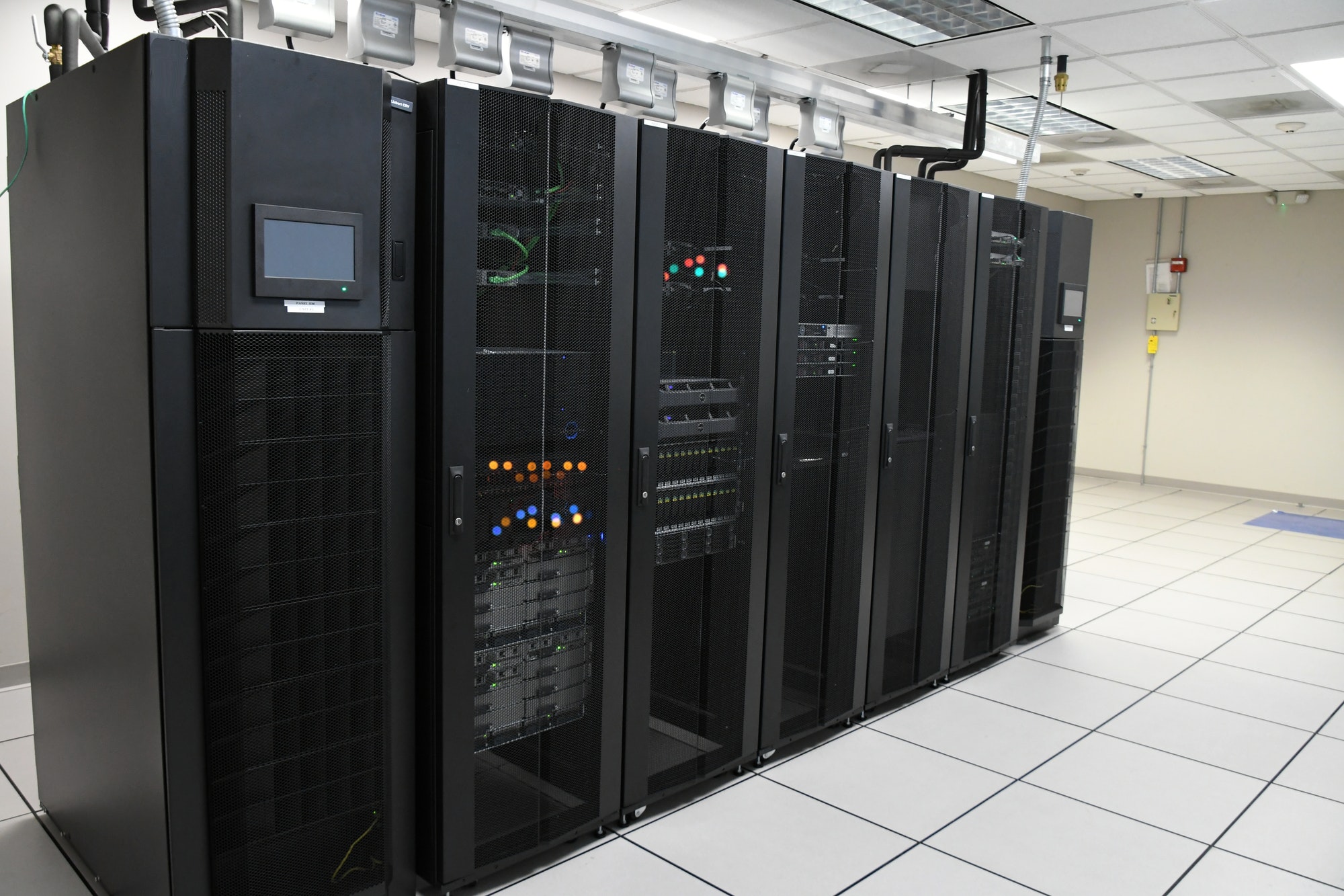 IT Department storage array server racks in a clean bright computer room at a company