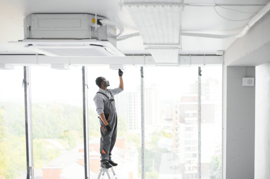 HVAC Technician Worker Testing Newly Installed Ventilation System.