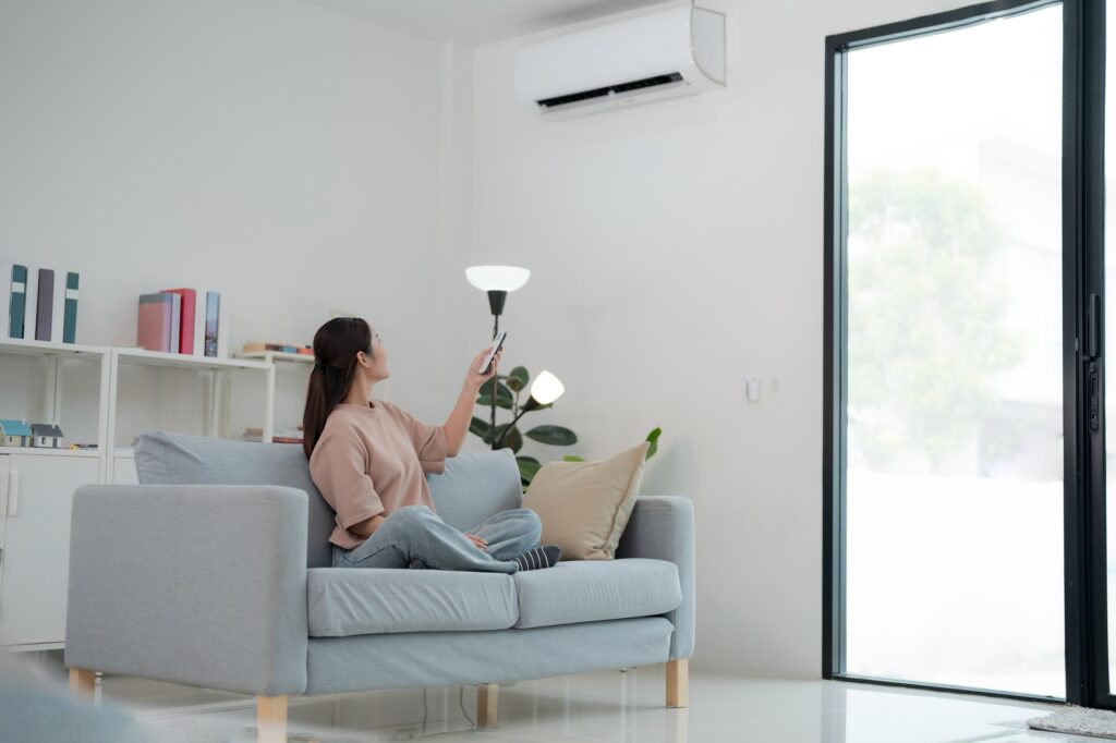 Woman enjoying air conditioning at home