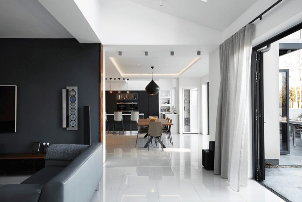 Control4 smart climate control panel in modern living room with comfortable seating.