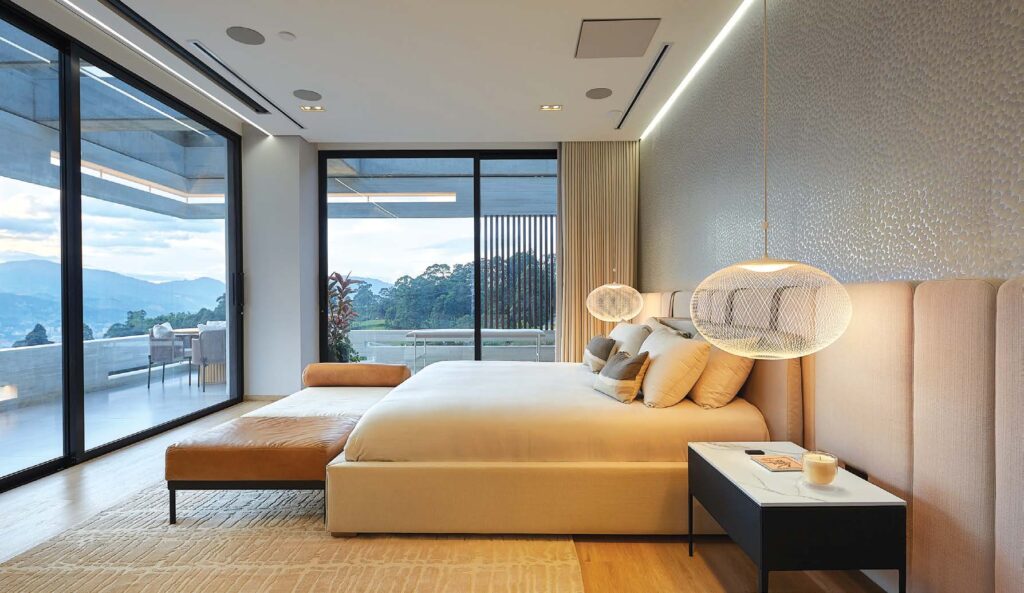 Lutron climate control panel in luxury bedroom with soft lighting and elegant furnishings.